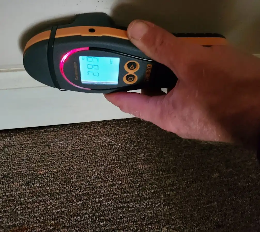 Moisture detection at baseboard during Storm Damage Restoration in Prien